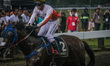 A jockey expresses his victory after a race during The Indonesia's Horse Racing Jateng Der...