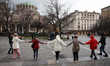 People dance at the Saint Nedelya Square as the Saint Nedelya Cathedral is seen in Sofia,...