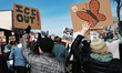 A demonstrator holds a placard reading ''ice out'' during a rally and demonstration at Jac...