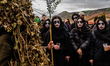 Women dressed as Quaresima watch the Rumita parade towards the town center in Satriano di...