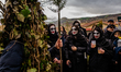 Women dressed as Quaresima watch the Rumita parade towards the town center in Satriano di...
