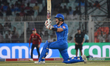 Italy's Ben Manenti watches the ball after playing a shot during match 29 of the T20 World...