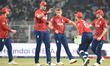 England's Sam Curran celebrates after taking the wicket of Italy's Gian-Piero Meade during...