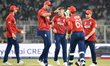 England's Sam Curran celebrates after taking the wicket of Italy's Gian-Piero Meade during...