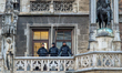 Police officers stand on the balcony of New Town Hall during a carnival event on Marienpla...