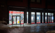 The storefront of a Rossmann drugstore is photographed with the entrance doors and brandin...