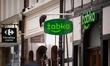 A Zabka convenience store sign is seen on Stagiewna Street with a Carrefour Express sign v...