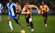 Vincent Young of Colchester United challenges Shayne Lavery of Cambridge United during the...