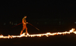 A daring tightrope walker crosses a burning wire high above the stage at the TransAlta Gra...