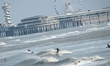 Surfers ride powerful North Sea swells at Scheveningen Beach in The Hague, Netherlands, on...