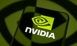 The Nvidia logo appears on a smartphone screen placed on a reflective surface onto which t...