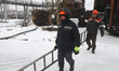 Workers from Kharkivoblenerho carry a ladder during repair works at an energy facility dam...