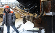An employee from Kharkivoblenerho stands near a valve as repair works are underway at an e...