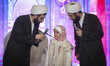 Two Iranian clerics ask a young girl whether she is afraid of the U.S. during the Internat...