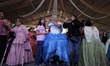 Senior women in Mexico City, Mexico, on February 21, 2026, dance a waltz while celebrating...