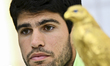 Carlos Alcaraz of Spain celebrates with the trophy after winning the men's singles final a...