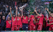 EA7 Emporio Armani Milano lifts the cup after winning the final match against Bertram Dert...
