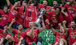 EA7 Emporio Armani Milano lifts the cup after winning the final match against Bertram Dert...