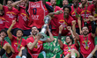 EA7 Emporio Armani Milano lifts the cup after winning the final match against Bertram Dert...
