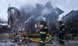 Firefighters work at a house ruined by a Russian attack in Sofiivska Borshchahivka village...