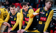 Szymon Kiejzik, Szymon Zapala, and Szymon Nowicki sit on the bench during the basketball g...