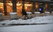 Workers clear the sidewalk outside an office building on Park Avenue in New York, United S...