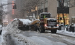 Workers using a backhoe clear the streets at Rockefeller Center in New York, United States...