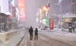 People take selfies as they brave the blizzard conditions as heavy snow falls in Times Squ...