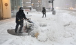 Workers clear out the snow on Fifth Avenue during a massive snowstorm in New York, United...