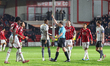 Referee Peter Wright shows the yellow card to Alex Pattison, number 23 of Walsall FC, duri...