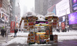 A snow-covered food cart is open for business in Times Square in Manhattan as blizzard con...