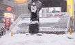 Snow accumulates in Times Square in Manhattan as blizzard conditions persist for a second...