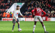 Dan Crowley of Milton Keynes Dons encourages his teammates to move as he holds up play dur...
