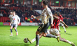Courtney Clarke of Walsall FC stretches to intercept the ball from Jon Mellish of Milton K...