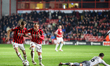 Charlie Lakin of Walsall FC and Alex Pattison of Walsall FC race forward as Liam Kelly of...