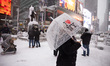 People gather despite heavy snow and wind in Times Square, as blizzard conditions persist...
