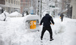 A person shovels snow in Manhattan as blizzard conditions persist for a second day in New...