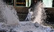 A maintenance worker cleans the sidewalk with a turbo broom on W.41st Street and Sixth Ave...