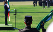 A female military member holds a Mexican flag while Mexico's President Claudia Sheinbaum P...