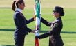 Mexico's President Claudia Sheinbaum Pardo receives the Mexican flag from a female militar...