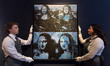 LONDON, UNITED KINGDOM - FEBRUARY 25, 2026: Art handlers hold ‘Four Mona Lisas’ by Andy Wa...
