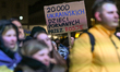 WARSAW, POLAND - FEBRUARY 24: A protester holds a cardboard sign that reads '20,000 Ukrai...