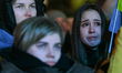 WARSAW, POLAND - FEBRUARY 24: Members of the Ukrainian diaspora watch speakers with tears...