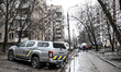 A police car parks outside a residential multi-storey building damaged as a result of a Ru...