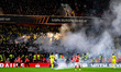 Smoke from flares drifts during the UEFA Europa League Knockout Round Play-off 2nd Leg bet...
