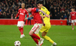 Neco Williams of Nottingham Forest is under pressure from Yigit Efe Demir of Fenerbahce du...