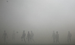 Footballers are seen during a break caused by flare smoke during Cracovia - Piast Gliwice...
