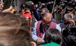 A representative of the secretary of tourism signs one of the petition sheets of the demon...
