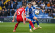 Oldham Athletic's Jack Stevens and Crawley Town's Charlie Barker battle for possession dur...