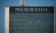 A tight telephoto close-up shows the Presidential hotel sign at the top of the LIM Center...